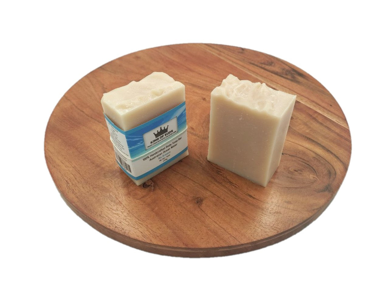 Two bars of soap on a wooden board with a white background