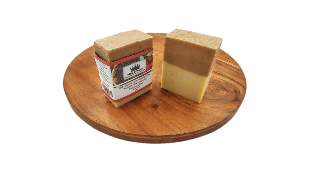 Two bars of soap on a wooden board with a white background