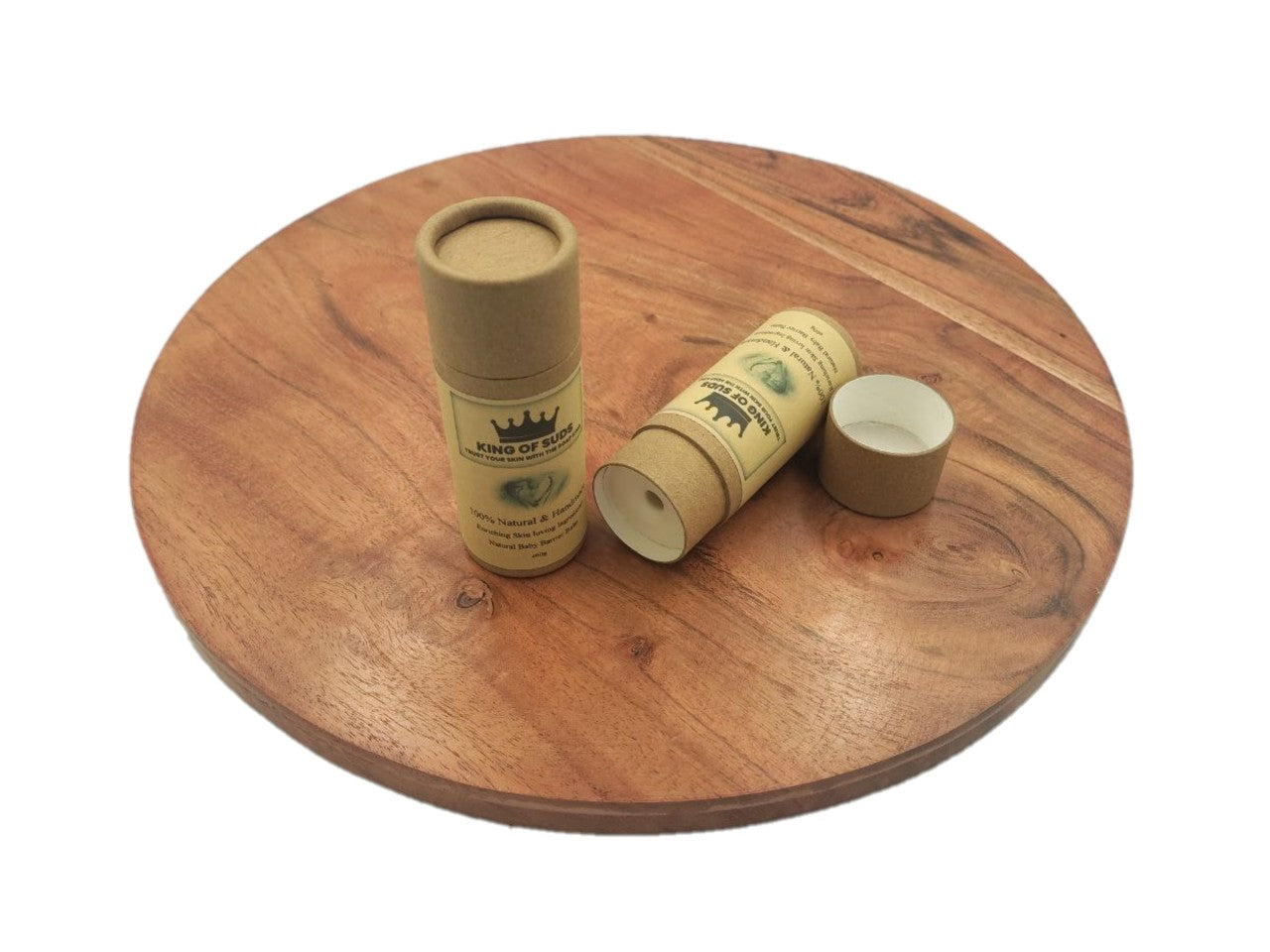 Two cardboard tubes balms with branding on a wooden surface