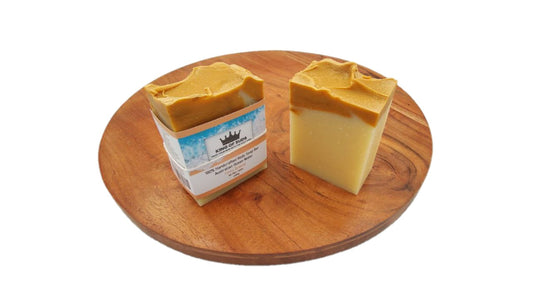 Two bars of soap on a wooden board with a white background