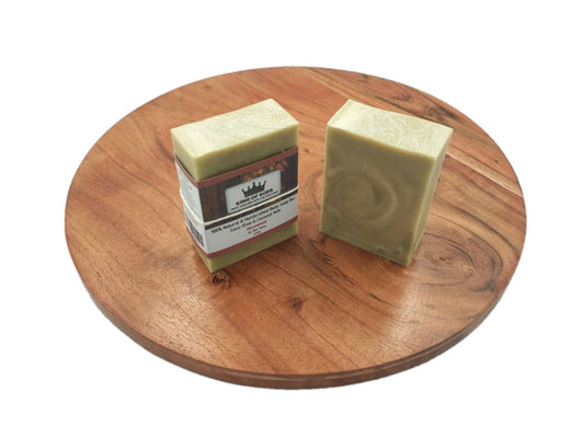 Two bars of soap on a wooden board with a white background