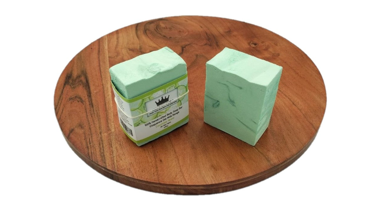Two bars of soap on a wooden surface with a white background