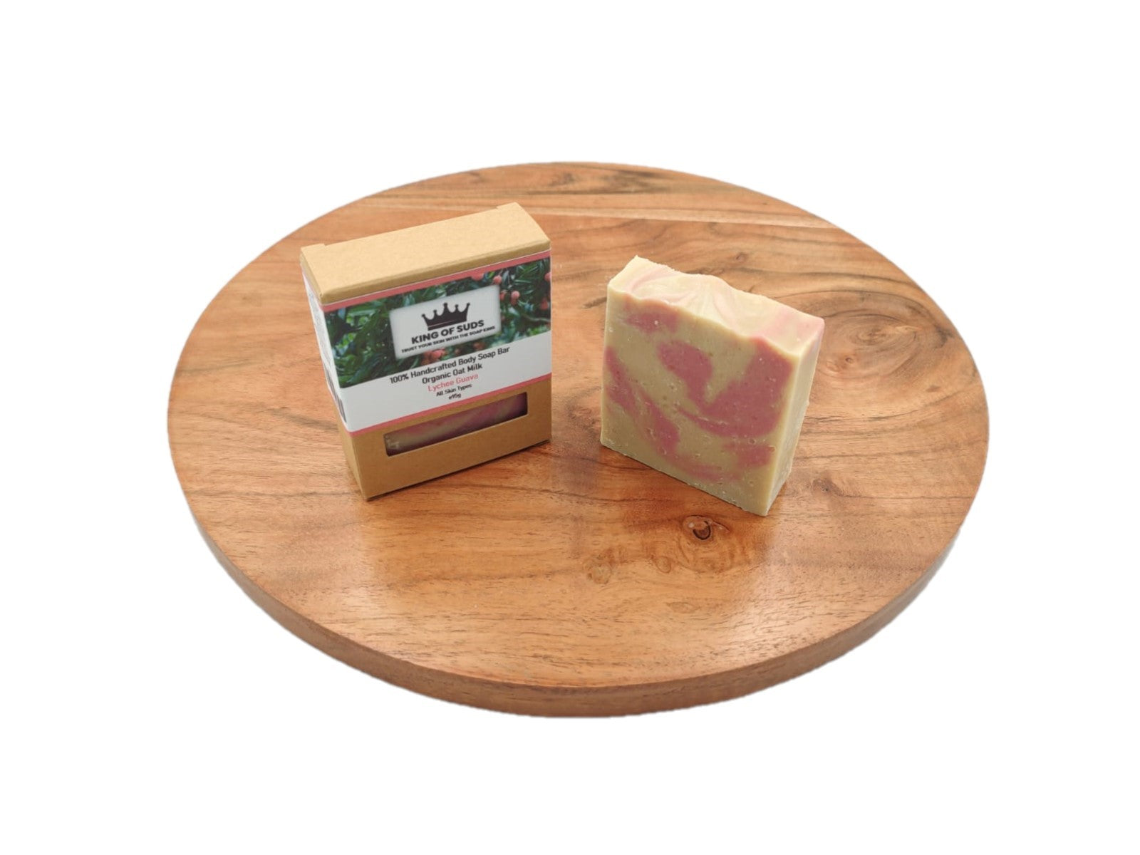 Two soap bars with a visible brand label on a wooden surface