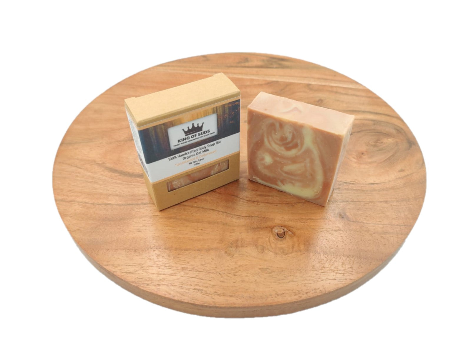 Two soap bars with a visible brand label on a wooden surface