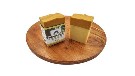 Two bars of soap on a wooden board with a white background