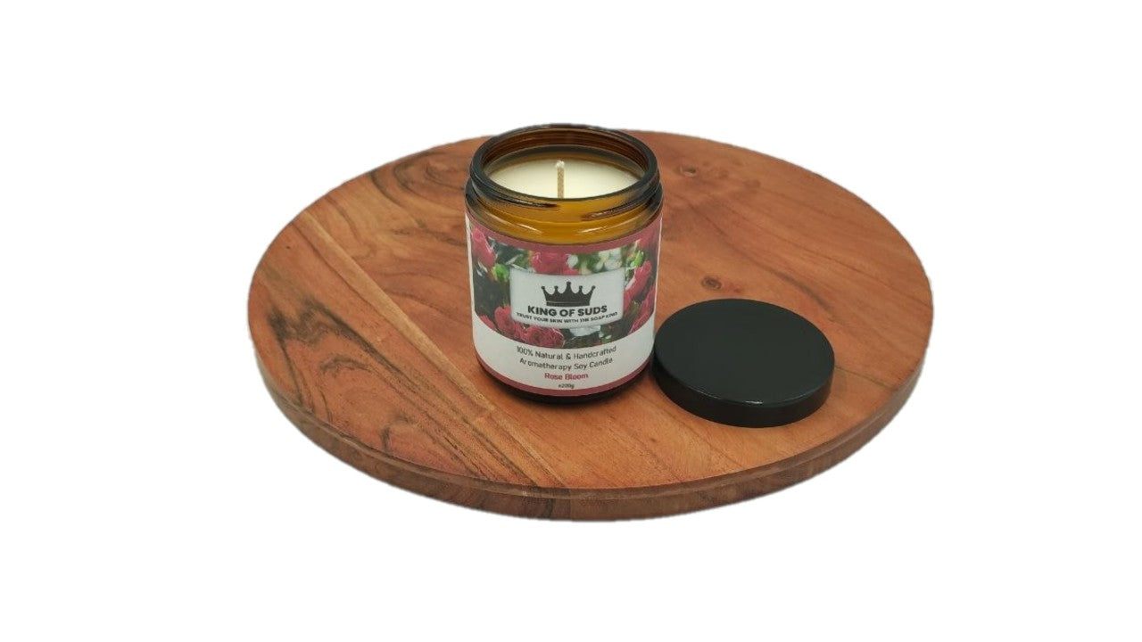 Candle in a glass jar with a label on a wooden coaster