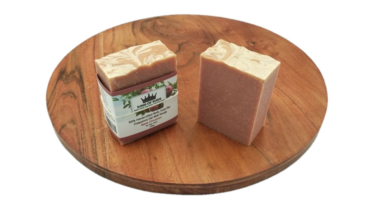 Two bars of soap on a wooden turntable with a white background