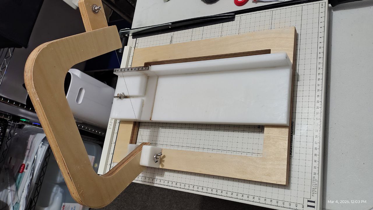 Wooden soap cutting frame with a grid on a cutting mat